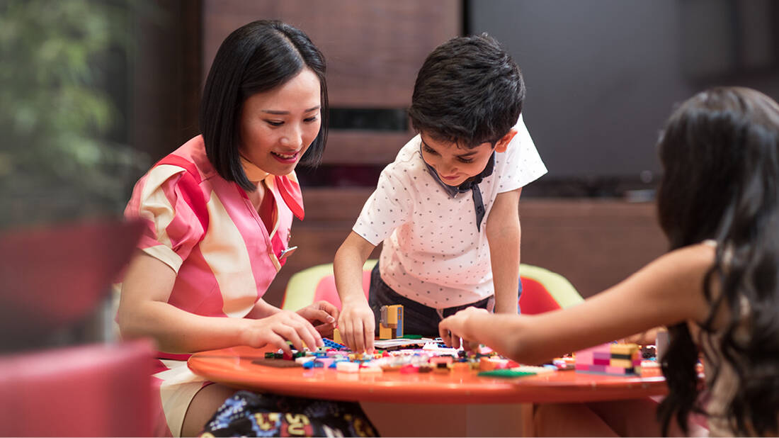 a marhaba representative playing with Legos with kids
