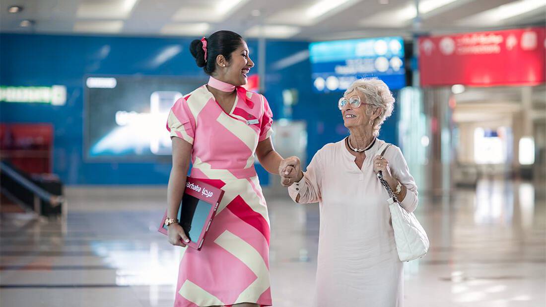 a marhaba representative accompanying elderly woman