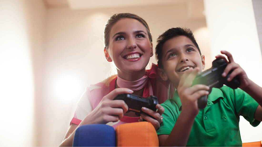 marhaba representative playing PlayStation games with child