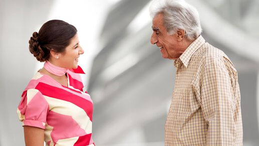 a female marhaba representative with an elderly man